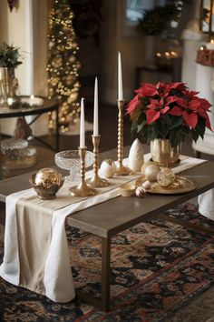 A coffee table styled with elegant Christmas decor, including gold candlesticks, ornaments, and red poinsettias for a sophisticated holiday look. Metallic Christmas Decor