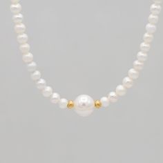 What can you always count on? Pearls to remain timeless year after year. Necklace is made with 6mm freshwater pearls and an 8mm pearl in the center centered between 14k gold filled rondelles. Necklace is finished with spring ring clasp. Measures 16 and 18 inches in length. Classic Beaded Necklaces With Round Beads, Dainty Round Bead Pearl Necklace, Classic Beaded Necklaces With Round Beads For Everyday, Classic Single Strand Beaded Necklaces, Dainty Yellow Gold Pearl Necklace With Round Beads, Classic Single Strand Beaded Necklace For Everyday, Elegant Everyday Hand-strung Necklaces, Everyday Pearl Drop Beaded Necklaces, Single Strand Akoya Pearl Beaded Necklace As Gift