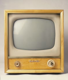 an old fashioned television sitting on top of a table