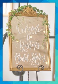 a welcome sign for the bride and groom to arrive at their wedding ceremony with greenery on top