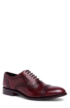 Brogue accents add charm to a stylish oxford topped with fine-grain leather while Goodyear welts ensure lasting durability. Leather upper and lining/rubber sole Imported Asian Owned/Founded Workwear Oxford With Brogue Detailing And Plain Toe, Plain Toe Oxford With Brogue Detailing For Work, Workwear Oxford Shoes With Brogue Detailing, Cap Toe Oxfords With Textured Sole For Work, Classic Business Casual Lace-up Shoes With Perforated Toe Box, Classic Oxford Lace-up Dress Shoes, Oxford Shoes With Brogue Detailing For Workwear, Cap Toe Oxford Shoes With Brogue Detailing For Work, Lace-up Oxfords With Leather Lining For Work