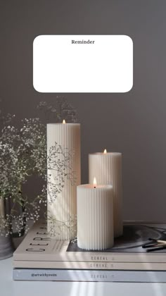 three white candles sitting on top of a table