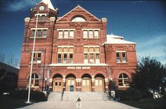 an old red brick building with a clock tower