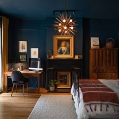 the bedroom is painted dark blue and has an old fashioned painting on the wall above the bed