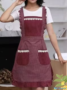 the woman is wearing an apron and smiling