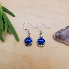 Visit our on-line shop at: Etsy.com/shop/AlbuquerqueDesigns *sterling silver earrings *dangles / drops / hooks / ear wires *southwestern jewelry *blue lapis / blue stone *calibrated pre-cut stones: 9x7mm oval shape *all jewelry items are made to ship, slight variations in stones will occur comparing to pictures. *size of a penny is 19mm or a dime is 18mm in diameter for comparing size with jewelry items. *handcrafted in USA *free small convenient gift box *free shipping in US, ship from US witho