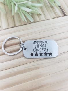 a metal keychain that says,'national support coworker '