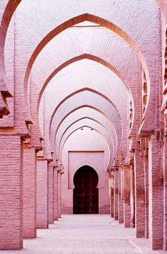 an archway in the middle of a building with arches and doorways on both sides