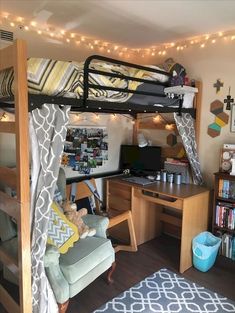 a bunk bed with a desk underneath it and some lights on the wall above it