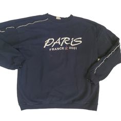 This vintage navy blue sweatshirt features an embroidered design of the Eiffel Tower and the word "Paris France". The sweatshirt has a classic fit with long sleeves, pullover closure, and a crew neckline. It is made of 100% cotton knit material that is machine washable. Quality fabric with white accent tuxedo stripe giving it an athletic style  This sweatshirt is perfect for world travelers and Paris enthusiasts. It is pre-owned with some flaws, but still in good condition. The size is M/L with Navy Blue Sweatshirt, Athletic Style, Blue Sweatshirt, The Eiffel Tower, Saree Look, White Accents, White Paint, Athletic Fashion, Saree Styles