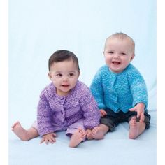 two babies sitting next to each other on a white background