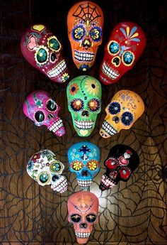 a group of colorful skulls sitting on top of a table