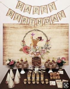 a table topped with lots of food and desserts next to a sign that says happy birthday