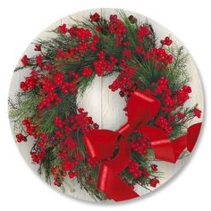 a christmas wreath with red bows and berries