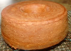 a round cake sitting on top of a cooling rack