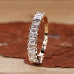 a diamond ring sitting on top of a wooden table