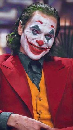 a man in a red suit and clown makeup