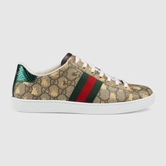 "Find GUCCI Ace Sneaker With Bees Gg Canvas on Editorialist. Since its debut, the Ace sneaker has become a mainstay of the House's collections. The retro-looking design is inspired by a Gucci sneaker from the 1970s, with the Web stripe along the sides. A metallic gold bees print embellishes the low-top silhouette. Beige/ebony GG Supreme canvas with gold bees print Green and red Web detail, Red leather detail on the back of one shoe and green the other, Rubber sole, Flat,.8\" height, Made in Italy, This style runs big, we recommend sizing down" Gucci Ace Sneakers, Gucci Gifts, Striped Sneakers, Gucci Sneakers, Gold Bee, Bee Print, Sneakers For Women, Leather Trainers, Gucci Shoes