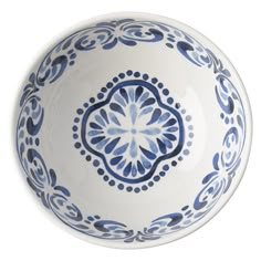 a blue and white bowl sitting on top of a table