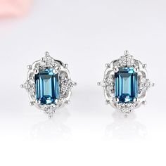 This vintage inspired dainty London blue topaz earrings are made of 925 solid sterling silver. ►Great for everyday wear or for any occasion. Suitable for all ages. All of our jewelry are handmade. Every gemstone is handpicked for the best quality.Center Stone: TopazColor: London BlueShape/Cut: Emerald Gem size: 6.0 x 4.0 mmCarat Weight: 2.3 ct. (approx.)Gemstone creation: NaturalHardness: 8.5Accent stones: simulated diamonds (cz)►Please note, every computer varies in shades and hues of color. Th Emerald Cut Earrings, London Blue Topaz Earrings, Popular Engagement Rings, Emerald Gem, Cut Earrings, Topaz Color, Topaz Necklace, Blue Topaz Earrings, Topaz Earrings