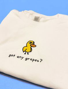 "got any grapes? Duck Shirt/Sweatshirt/Hoodie got any grapes? Inspired by the iconic \"Duck Song\". Made of a premium quality cotton blend for a great quality soft feel, and comfortable retail fit. Our embroidery is crafted for long-lasting quality so your garment stays looking fantastic. Fabric: Shirt: 100 % Cotton Sweatshirt: 50% Cotton 50% Polyester Hoodie: 80% Cotton 20% Polyester Weight: Shirt: 180 GSM Sweatshirt and Hoodie: 280 gsm Shop With Total Confidence - If something's not quite righ Got Any Grapes Duck, Cute Funny Sweatshirts, Embroidery Inspiration Sweatshirt, Fun Merch Ideas, Duck Things To Buy, Fun Clothes Aesthetic, Thrift Sweatshirts, Cricut Clothing Projects, Fun Tshirt Designs