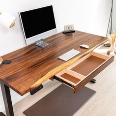 a desk with a computer monitor, keyboard and mouse