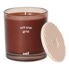 an off the grid candle next to it's lid