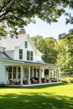 a large white house sitting on top of a lush green field