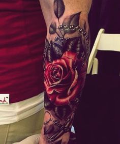 a person with a rose tattoo on their arm