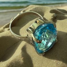 Introducing our stunning Aqua Marine Rings ! A timeless symbol of elegance and beauty! Dive into this world of mesmerizing blue hues that capture the essence of the ocean. Each ring is meticulously crafted to perfection, exuding a sense of luxury and sophistication. Whether you're looking for a statement for a special occasion or a daily reminder of the sea, our Aqua Marine Rings are the perfect choice. Let the refreshing energy of aqua marine inspire you and elevate your style to new heights. Make a splash with your jewelry collection and indulge in the allure of Aqua Marine Rings. Order yours today and experience the magic of the sea at your fingertips. Ocean-Inspired Beauty you must wear the ocean's hues on your finger! We offer them here at Amazonian Girl in 18K Gold and Silver. And In Elegant Ocean Color Jewelry For Gifts, Timeless Blue Diamond Cut Jewelry, Luxury Oval Sapphire Ring With Polished Finish, Elegant Blue Topaz Diamond Ring For Formal Occasions, Luxury Hallmarked Topaz Rings, Dazzling Aquamarine Rings For Formal Occasions, Luxury White Gold Ring With Aquamarine, Luxury White Gold Aquamarine Ring, Luxury Blue Topaz Ring With Vs Clarity