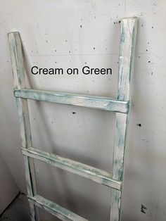 an old ladder is painted white and has the words cream on green written below it