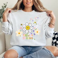 Welcome the blooming season in style with our "Hello Spring" Crewneck Sweatshirt!  Embrace the cozy vibes of spring with this delightful sweatshirt featuring a charming floral nature design, perfect for adding a touch of springtime cheer to your wardrobe. Crafted with comfort in mind, this trendy aesthetic sweatshirt offers both style and warmth, ensuring you stay cozy and fashionable throughout the season. Available in plus sizes, everyone can enjoy the fresh and vibrant look of springtime flowers in this must-have sweater. Bring a burst of springtime joy to your wardrobe with our "Hello Spring" Crewneck Sweatshirt.  Whether you're out for a casual stroll or lounging at home, this sweatshirt is the perfect companion for embracing the beauty of the season. Made with high-quality materials Spring Crewneck, Spring Season Flowers, Spring Sweatshirt, Aesthetic Sweatshirt, Flower Sweater, Trendy Aesthetic, Hello Spring, Spring Wardrobe, Cozy Sweatshirts