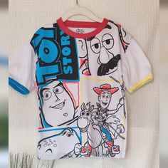 This Playful T-Shirt Features A Colorful Design Perfect For Any Young Toy Story Fan. The Shirt Is White With Contrasting Red, Blue And Yellow Trim For Added Style. The Front Graphic Showcases Beloved Characters Buzz Lightyear, Mr. Potato Head, Woody, And Rex In A Fun And Dynamic Layout. Made From Comfortable And Durable Materials. Size: 5/6 Color: White (Red, Blue, Yellow Accents) Material: 79% Polyester, 30% Cotton Care: Machine Wash Approx Measurements: Shoulder To Shoulder 14", Armpit To Armp Playful Cartoon Print T-shirt For Playwear, Disney Cotton Tops For Playwear, Blue Fun Top For Play, Fun Character Print Tops For Playtime, Themed Multicolor Tops With Cartoon Print, Themed Multicolor Cartoon Print Tops, Disney Character Print T-shirt For Summer, Multicolor Disney Crew Neck T-shirt, Character Print Crew Neck T-shirt For Playtime