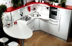 a kitchen with red counter tops and white cabinets is pictured in this image, it appears to be very modern