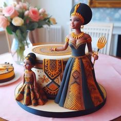 a cake decorated with an african woman and child