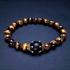 Tiger Eye - lets you see everything. Use it for insight and you can be a very lucky person. When used in jewelry the tiger eye may bring good luck and protection from the evil eye to the wearer. It is also known to bring clear thinking and insight. Style: ClassicShape\pattern: CROWNOcassion 4: Friendship braceletOcassion 3: Lover braceletsOcassion 2: bracelets giftOcassion 1: Couple braceletsMaterial : Natural Stones braceletGender: UnisexChain Type: Beaded Bracelet Male Bracelets, Bracelet And Watch, Asian Room, Mens Bracelet Fashion, Diy Necklace Patterns, Bead Bracelet Ideas, Bracelet Materials, Making Bracelets With Beads, Lovers Bracelet