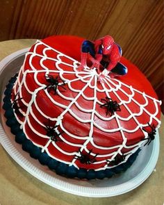 a spiderman cake on a white plate