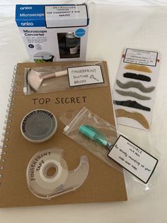 the contents of a top secret kit are displayed on a white sheet with brown paper