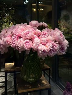 a vase filled with pink flowers sitting on top of a table