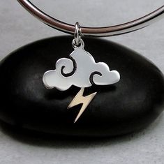 "This Storm Cloud Charm comes with a silver jump-ring as pictured. Please note that photo is not to scale and may appear larger to show detail. Refer to exact measurements below. Additional attachments (lobster clasp, large-hole bead, necklace chains) are available from the charm-attachments drop-down menu.  For a visual example of the different attachments and what each one is best suited for, scroll through the photos until you see the example photo or visit https://etsy.me/2BY7DAW for detailed information.    { DETAILS } ★ Material: Sterling Silver  ★ Finish Color: Silver  ★ Measurements: 5/8\" x 3/4\" ★ Dimensions: One-sided { SIMILAR ITEMS }  More weather themed items available from my shop: https://www.etsy.com/shop/treasuredcharms/search?search_query=weather { GIFT OPTIONS} Gift box Write Song Lyrics, Pandora Beads, Thunder And Lightning, Rain Cloud, Large Hole Beads, Storm Clouds, Rainy Weather, Necklace Charm, Bracelet Charm