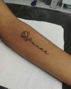 a person with a tattoo on their arm that says, love is forever written in cursive writing