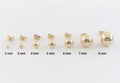 A pair of Fabulous 14k Yellow Gold Ball Stud Earrings!! Prices in the listing are for a pair. All the earrings are in real gold including the back and they won't tarnish. Material: Real 14k gold, Stamped on the back Ball Sizes: From left to right: 2 mm: 8 mm long post, recommended for kids and thin ear lobes 3 mm: 8 mm long post, recommended for kids and thin ear lobes 4 mm: 8 mm long post, recommended for adults and thin ear lobes 5 mm: 8 mm long post, recommended for adults and thin ear lobes Heavy Earrings, Ball Stud Earrings, Tiny Earrings, Girls Earrings, Jewelry Earrings Hoops, Gold Studs, Real Gold, Jewelry Earrings Studs, Gold Earrings