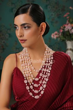 The pink stone necklace with shell pearls is flawlessly handcrafted by the artisans of India to celebrate beauty with the heritage of rich old Indian Jewelry. The five-layered stone necklace is designed to give you a breezy color therapy. Add a punch of soft colors to your style and watch the heads turn. Make your mark and pair this statement long necklace with your festive or contemporary ensembles. Necklace Closure - Lobster Hook Style Tip - This design is a perfect intersection of bohemian an Pink Gemstone Beads Necklace For Wedding, Exquisite Pink Gemstone Necklaces, Long Gemstone Beads Necklace For Wedding, Exquisite Pink Gemstone Necklace, Long Wedding Necklace With Gemstone Beads, Traditional Pearl Necklace With Gemstone Beads, Pink Temple Jewelry Necklace With Round Beads, Elegant Pink Pearl Gemstone Necklace, Handmade Pink Bridal Necklace