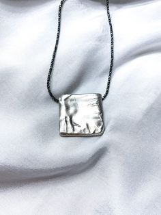 "Ashley - Handmade Square locket pendant This one-of-a-kind pendant was created using the lost wax casting technique. It was first handcrafted from wax and then cast in silver, resulting in a truly unique piece. Designed to bring a fresh and stylish touch to both everyday wear and special occasions, this pendant embodies perfection in silver, adding a touch of elegance to any necklace. ✤ DETAILS ✤ * Material: 925 Silver * 100% Hypoallergenic & Tarnish Resistant, no green skin! ✤ HOW TO ORDER ✤ *Choose your desired length from the dropdown menu, then click \"\"Add to Cart\"\" and proceed to checkout. ➢ MORE NECKLACE: https://www.etsy.com/shop/NiahJewelryDesign?ref=shop-header-name&listing_id=1361449260&section_id=37996777 ➢ BACK TO MY SHOP: https://www.etsy.com/il-en/shop/NiahJewelryDesign Minimalist Handmade Necklace For Keepsake, Artisan Necklace With Rectangular Pendant As A Gift, Oxidized Pendant Necklace For Gift, Hand Cast Round Pendant Jewelry For Gift, Artisan Rectangular Pendant Necklace As A Gift, Hand-cast Round Pendant Jewelry Gift, Artisan Style Rectangular Pendant Necklace As Gift, Oxidized Finish Pendant Necklace For Gift, Handmade Amulet Necklace For Everyday Wear