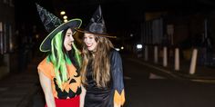 two women dressed up in halloween costumes standing next to each other