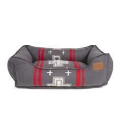 the dog bed is made from grey fabric with red stripes and crosses on it, which are