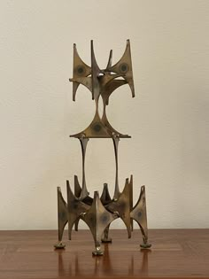 a metal sculpture sitting on top of a wooden table