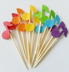 colorful music notes are on sticks with toothpicks