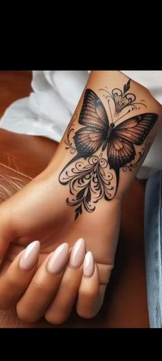 a woman's foot with a butterfly tattoo on it