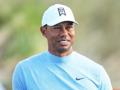 tiger woods wearing a nike hat and blue shirt